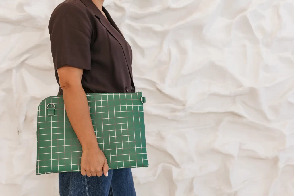 Kirsten walking holding her work satchel